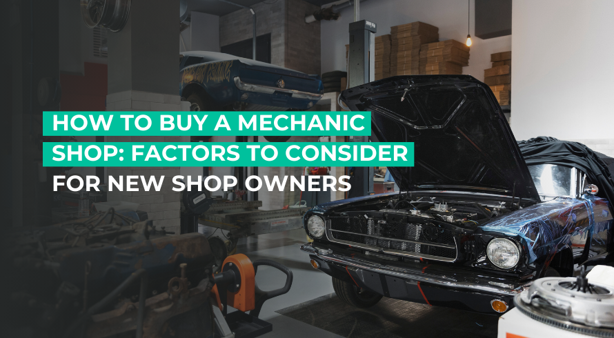 Mechanic shop with mechanic standing next to a car with its hood popped up