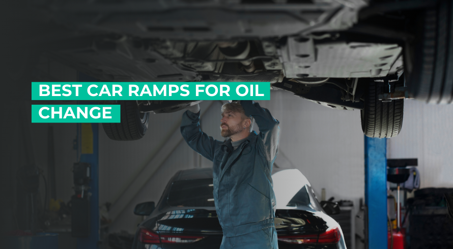 Mechanic working on car that's lifted by oil change ramp